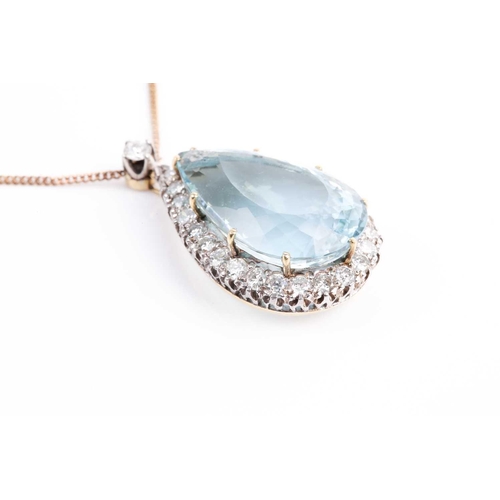 61 - A diamond and aquamarine cluster pendant, the pear cut aquamarine within a border of brilliant cut d... 