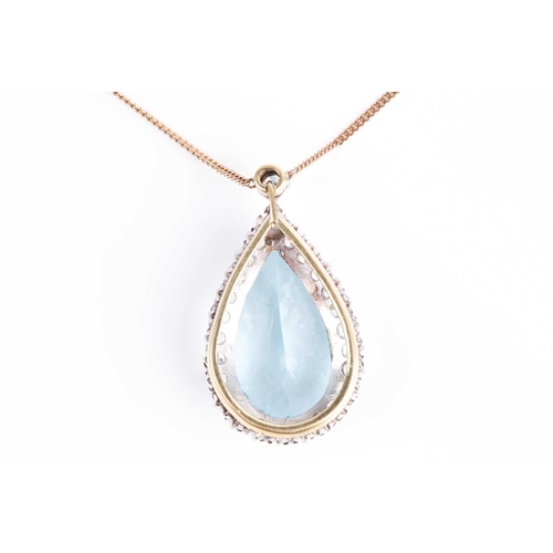 61 - A diamond and aquamarine cluster pendant, the pear cut aquamarine within a border of brilliant cut d... 