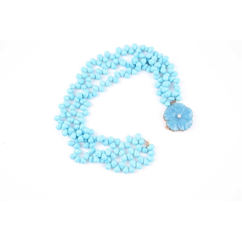 70 - A turquoise-coloured bead necklace, possibly dyed howlite, set with three strands of rounded pear-sh... 