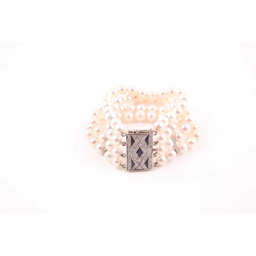 72 - A diamond and pearl bracelet, comprised of four rows of round cultured white pearls, approximately 7... 