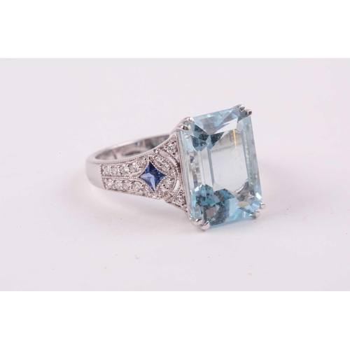 74 - An aquamarine, diamond and sapphire cocktail ring, the baguette cut aquamarine weighing approximatel... 