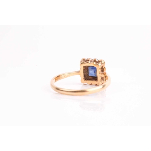 90 - An early 20th century sapphire and diamond cluster ring, the calibre cut sapphire in millegrain moun... 