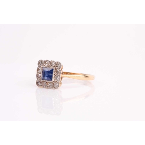 90 - An early 20th century sapphire and diamond cluster ring, the calibre cut sapphire in millegrain moun... 