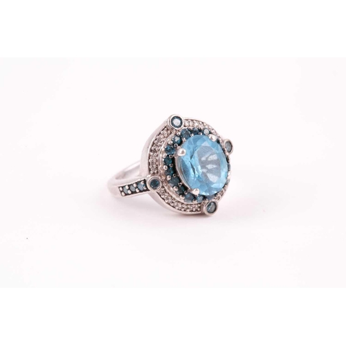 91 - A silver, topaz, and diamond ring, set with a mixed oval-cut blue topaz, surrounded with small blue ... 