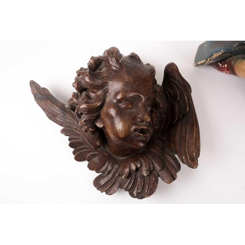 108 - A 19th-century plaster cast putti's masque, with wings painted to simulate carved wood, probably for... 