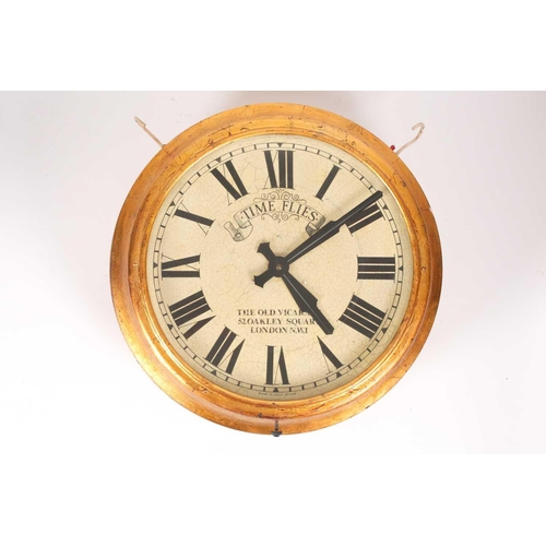 2 - A gilt-cased double-sided, circular, electric station clock. The white dials bearing a faux patinate... 