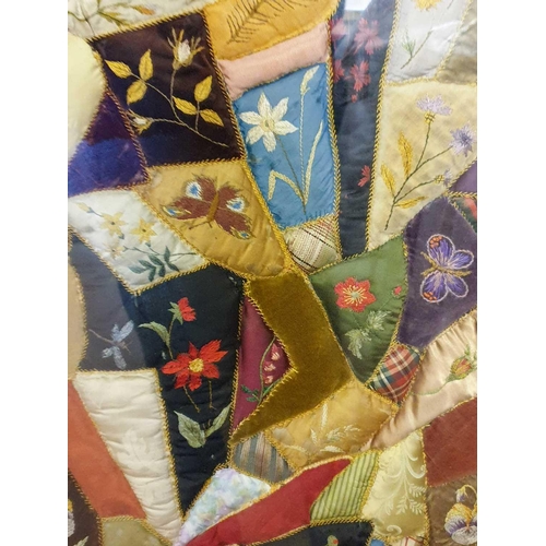 43 - A framed late 19th century possibly American patchwork quilt of irregular segments including silks, ... 