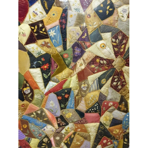 43 - A framed late 19th century possibly American patchwork quilt of irregular segments including silks, ... 