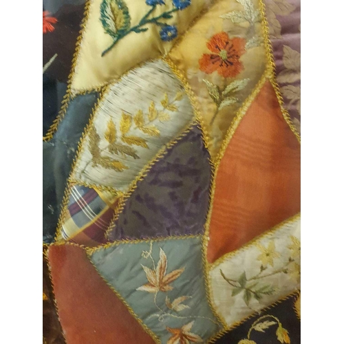 43 - A framed late 19th century possibly American patchwork quilt of irregular segments including silks, ... 