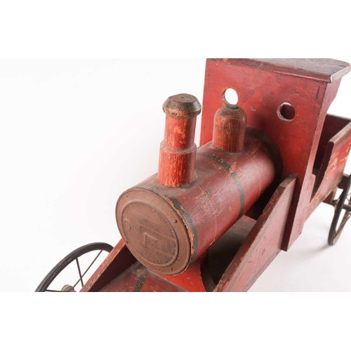 53 - A vintage, presumably American folk art, crimson painted wood, pull along steam engine with spoked w... 