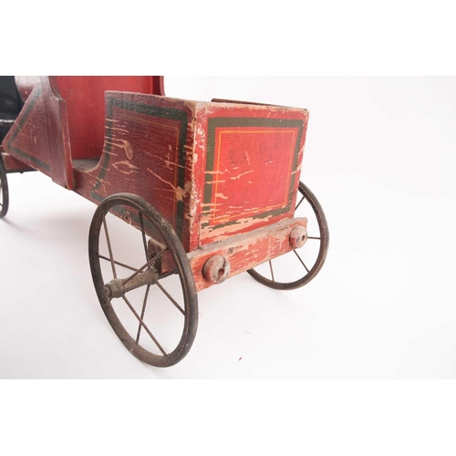 53 - A vintage, presumably American folk art, crimson painted wood, pull along steam engine with spoked w... 