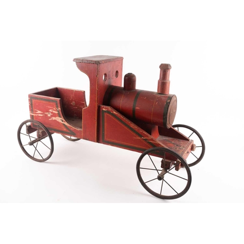 53 - A vintage, presumably American folk art, crimson painted wood, pull along steam engine with spoked w... 