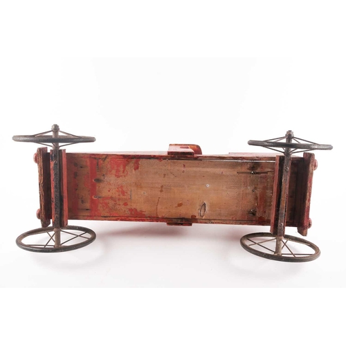 53 - A vintage, presumably American folk art, crimson painted wood, pull along steam engine with spoked w... 