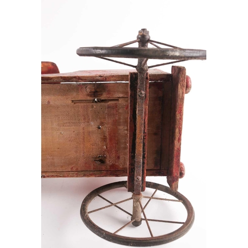 53 - A vintage, presumably American folk art, crimson painted wood, pull along steam engine with spoked w... 