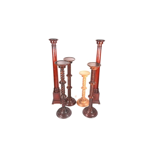 69 - A pair of turned and stained pine masonic, Doric columns with dished tops and architectural plinth b... 