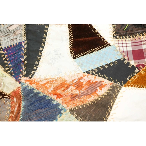 74 - A late 19th century possibly American patchwork quilt of satin, velvet, damasks, and other fabrics a... 