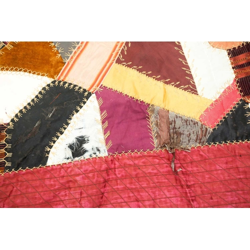 74 - A late 19th century possibly American patchwork quilt of satin, velvet, damasks, and other fabrics a... 