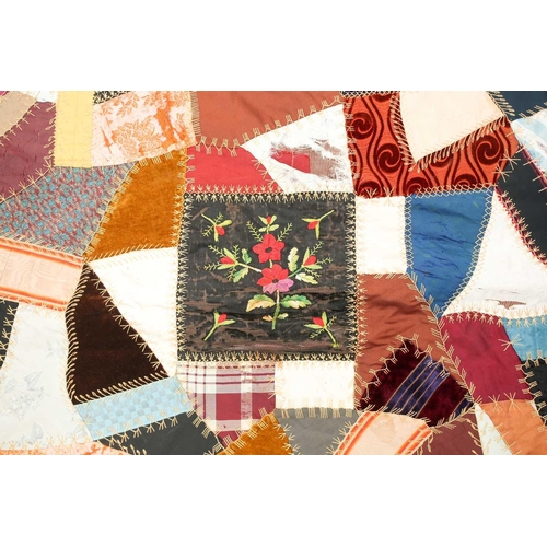 74 - A late 19th century possibly American patchwork quilt of satin, velvet, damasks, and other fabrics a... 