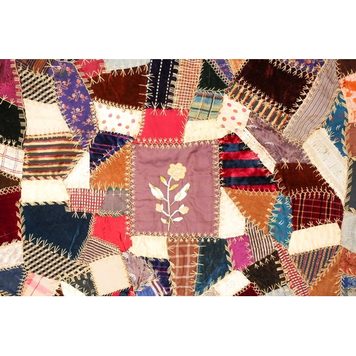 74 - A late 19th century possibly American patchwork quilt of satin, velvet, damasks, and other fabrics a... 