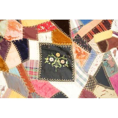 74 - A late 19th century possibly American patchwork quilt of satin, velvet, damasks, and other fabrics a... 