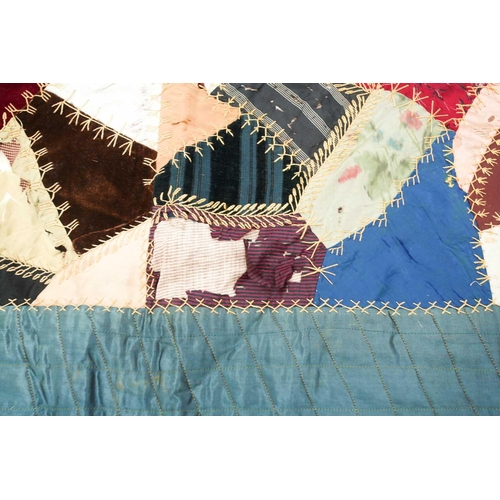 74 - A late 19th century possibly American patchwork quilt of satin, velvet, damasks, and other fabrics a... 