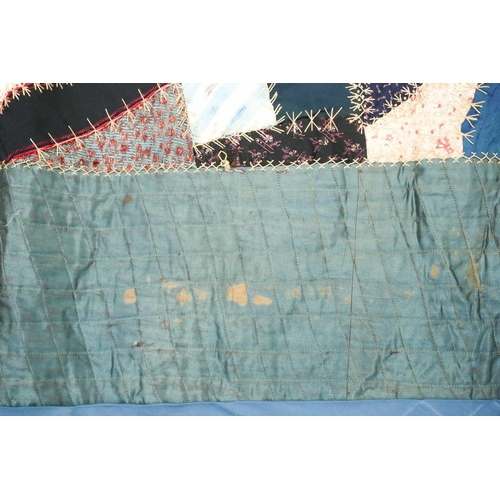 74 - A late 19th century possibly American patchwork quilt of satin, velvet, damasks, and other fabrics a... 