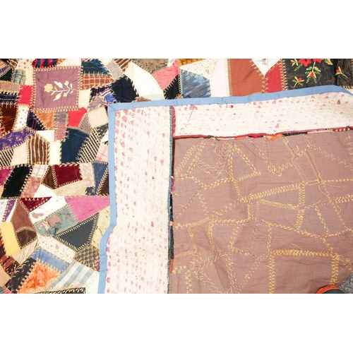 74 - A late 19th century possibly American patchwork quilt of satin, velvet, damasks, and other fabrics a... 