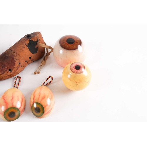 84 - A group of assorted novelty plastic eyeball objects either modelled as paperweights and hanging pend... 