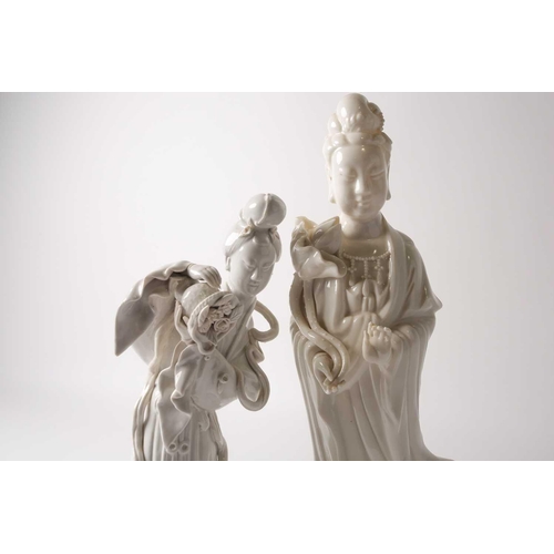 84 - Two Chinese blanc de chine figures, Guanyin & Lan Caihe, 20th century, Guanyin holding a lotus bud, ... 