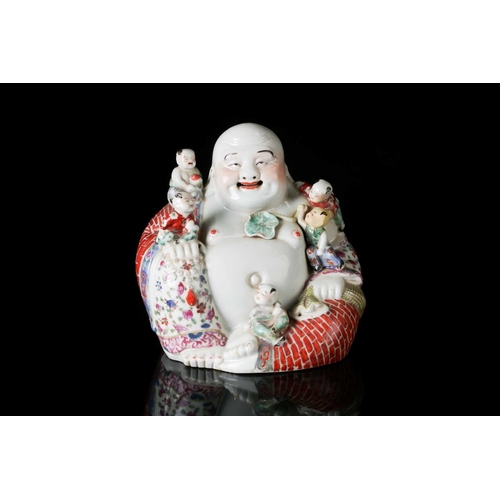 85A - A Chinese 20th century Famille rose, porcelain figure of the corpulent, seated Hotei with red-brick ... 