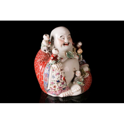 85A - A Chinese 20th century Famille rose, porcelain figure of the corpulent, seated Hotei with red-brick ... 