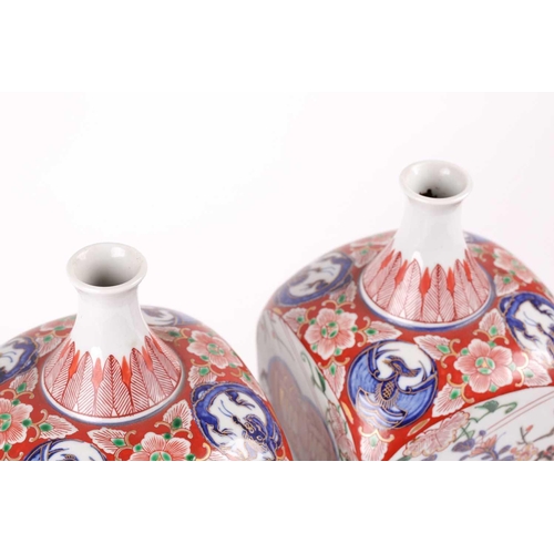 88 - A pair of Arita Imari square vases, circa 1900, based upon gin bottles of the 17th century, the neck... 