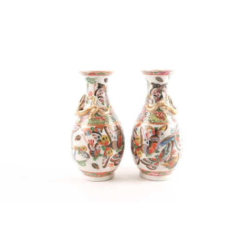 94 - A pair of Chinese Canton enamel vases, second half 19th century, the shoulders with applied gilt chi... 