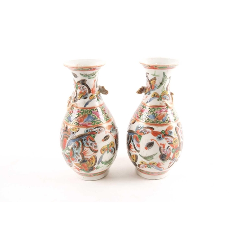 94 - A pair of Chinese Canton enamel vases, second half 19th century, the shoulders with applied gilt chi... 