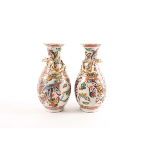 94 - A pair of Chinese Canton enamel vases, second half 19th century, the shoulders with applied gilt chi... 