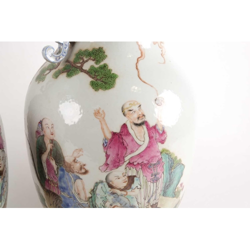 97 - A pair of large Chinese Famille rose porcelain baluster vases with pieced cloud handles. Probably la... 