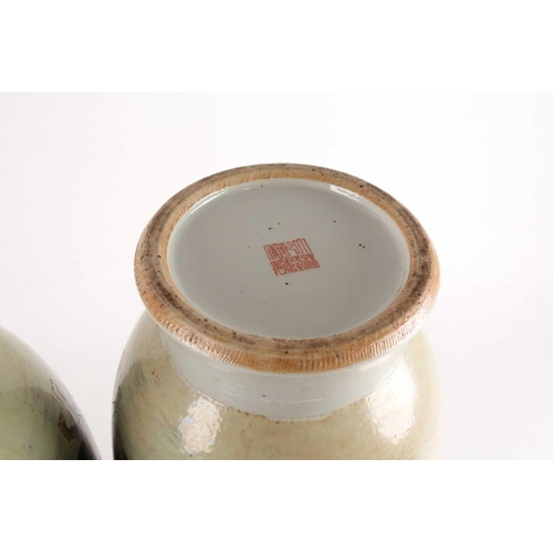 97 - A pair of large Chinese Famille rose porcelain baluster vases with pieced cloud handles. Probably la... 