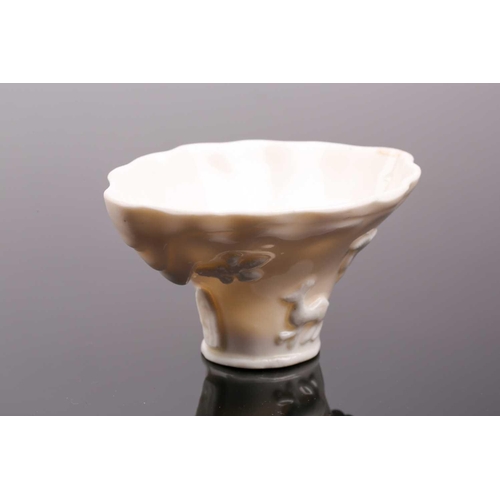 101 - A Chinese blanc de chine libation cup, Qing dynasty, 19th century, with applied relief moulded tiger... 