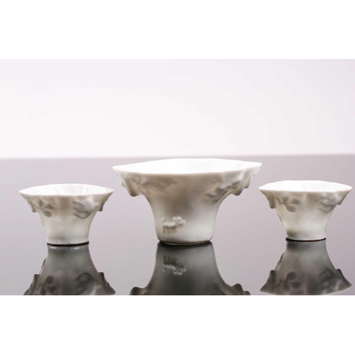 102 - Three Chinese blanc de chine libation cups, 19th/20th century, each of typical form, with moulded dr... 