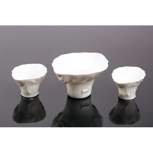 102 - Three Chinese blanc de chine libation cups, 19th/20th century, each of typical form, with moulded dr... 