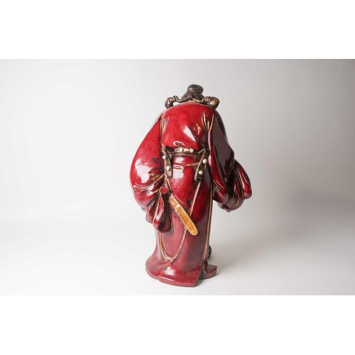 105 - A Shiwan flambe glaze figure of Guandi, mid 20th century, a fierce expression upon his face, modelle... 