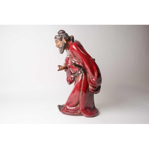 105 - A Shiwan flambe glaze figure of Guandi, mid 20th century, a fierce expression upon his face, modelle... 