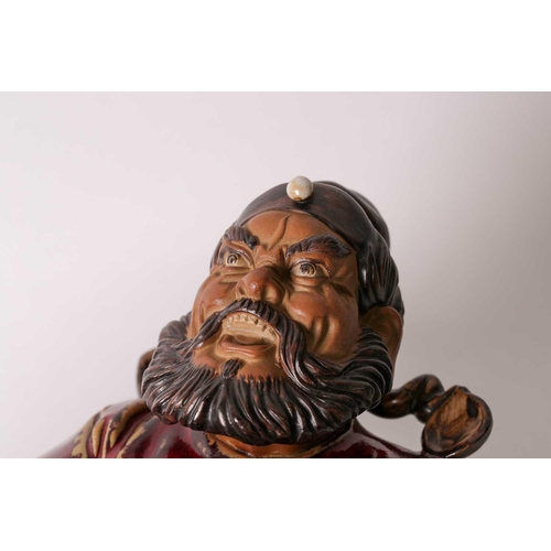 105 - A Shiwan flambe glaze figure of Guandi, mid 20th century, a fierce expression upon his face, modelle... 