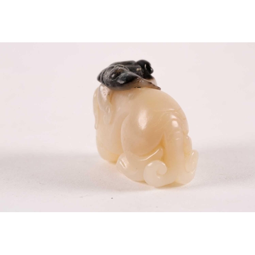 127 - A Chinese, carved off-white and grey jade, Tang-style crouching lion. 81 grams 5 cm long x 3.8 cm hi... 