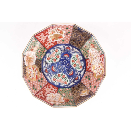 130 - A Japanese Imari porcelain decagonal dish, late Meiji period. Painted with alternating panels of sty... 