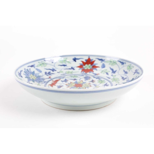 134 - A Chinese Wucai shallow bowl, 20th century, painted with lotus flowers and tendrils, pseudo six char... 