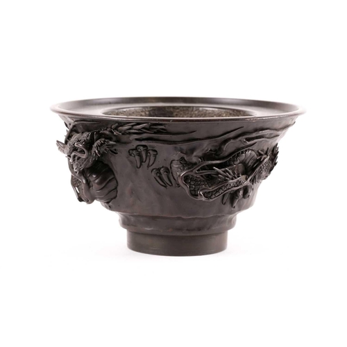 140 - A Japanese bronze censer, Meiji period, of circular tapering form, with applied dragon amongst whisp... 