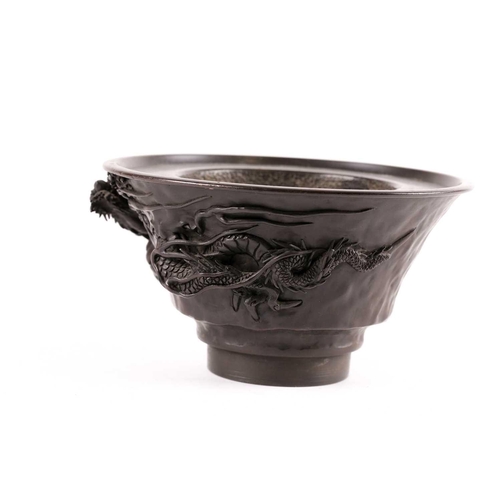 140 - A Japanese bronze censer, Meiji period, of circular tapering form, with applied dragon amongst whisp... 