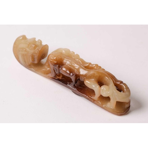 156 - A Chinese jade belt hook, late Ming/early Qing, the pierced body carved with a chilong, terminating ... 