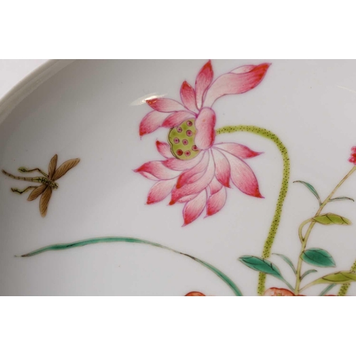 159 - A Chinese famille rose saucer dish, painted with lotus flowers and leaves and a dragonfly, pseudo si... 